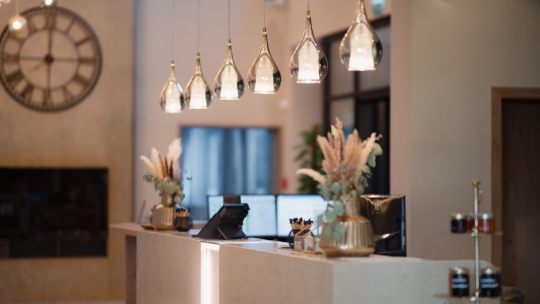Elegant hotel reception with modern lamps and decorations.